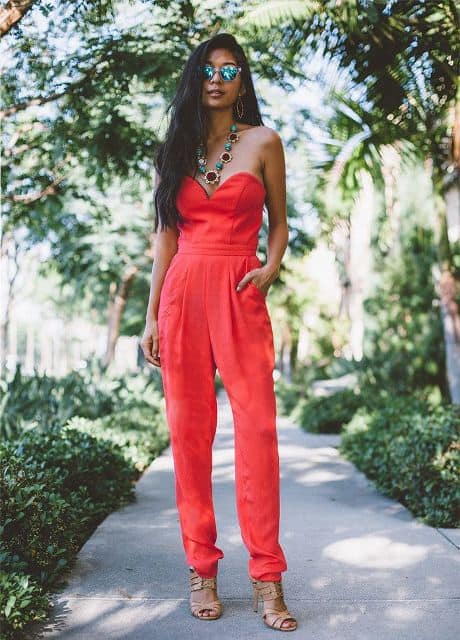 With beige shoes and statement necklace