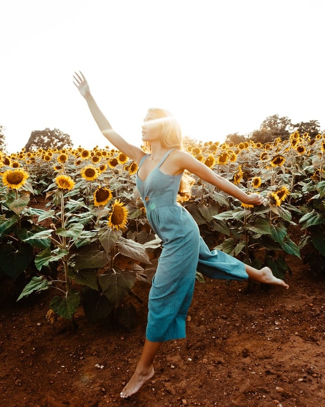 girl in blue jumpsuit jumping